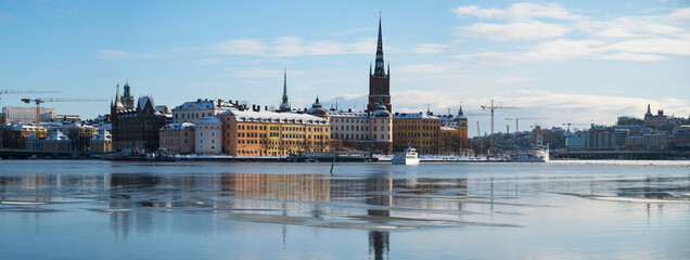 Winter view over the old part of Stockholm a cold day, icy bay at the island riddarholmen. 