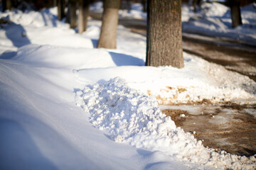 Piles of snow cleared from the sidewalks