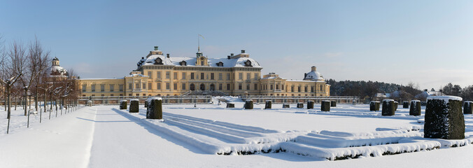 Fototapeta na wymiar Snowy winter view over the Drottningholm island with castle and the French park in Stockholm