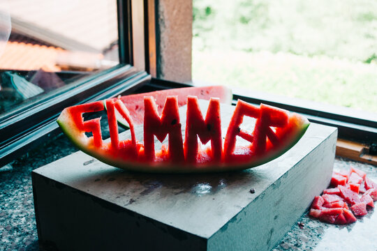 The word ""summer"" sculptured on a watermelon slice