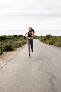 Woman running trail at the beach