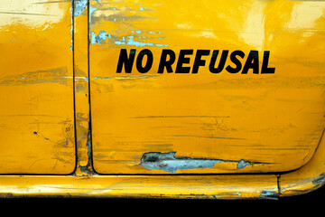 NO REFUSAL written on a yellow colored taxi