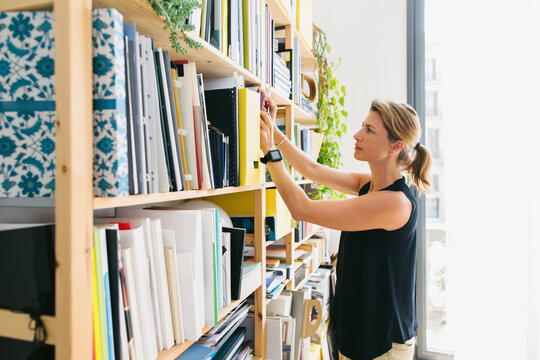 Mature female designer working at her office. - Powered by Adobe