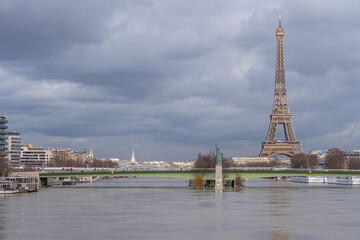 Paris, France - 02 05 2021: Panoramic view of the Seine during flood with the Statue of Liberty Paris, Grenelle Bridge the Eiffel Tower and  Grenelle district