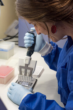 Female scientist on a laboratory working with a multi-pipette and a DNA chip