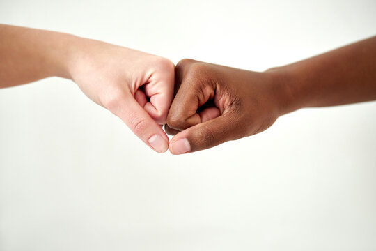 close up of diverse female hands holding together isolated over white background. diversity, support, friendship concept.