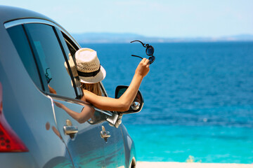 driver girl  in car at sea in summer