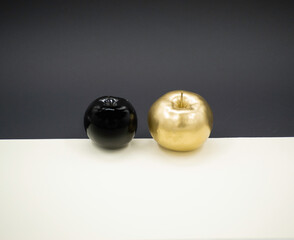 Black and gold apple on a black- beige background.