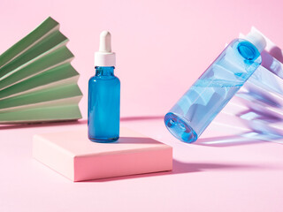 Hyaluronic acid oil serum generic bottle treatment and toner on pink geometric background with pastel color paper fan