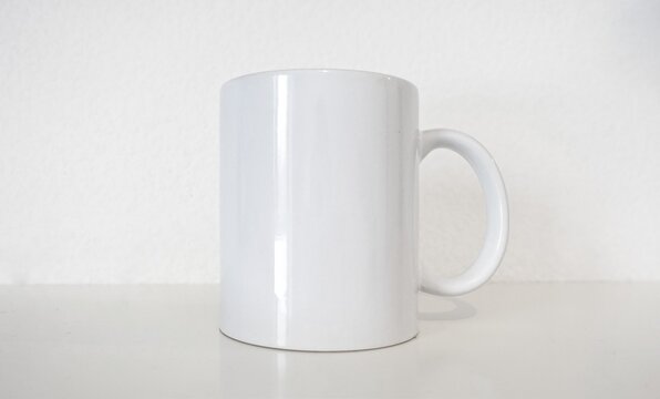 White ceramic cup mock up for coffee or tea logotype and branding. 