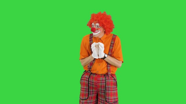Cunning clown thinking having some evil thoughts on a Green Screen, Chroma Key.