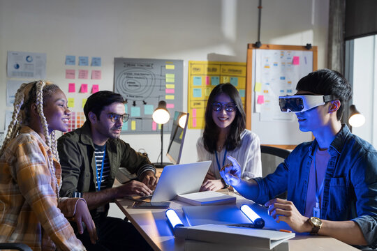 A team of developers working with virtual reality glasses during business meetings.