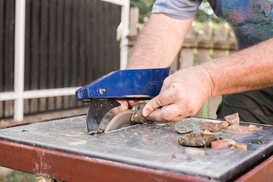 Close up of a Man Cutting Stones