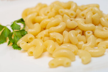 Boiled yellow pasta on a white plate.