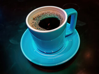 Porcelain coffee cup with saucer on a table in a cafe