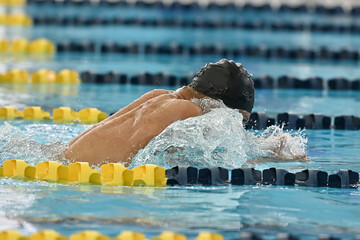 Boy swimming competitively at a swim meet