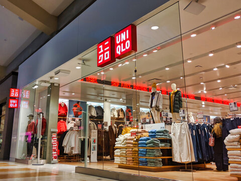 Bellevue, WA / USA - November 1st, 2019: Uniqlo clothing store in a mall,  with lots of different fall and winter clothing on display and on sale.  Stock Photo | Adobe Stock