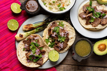 Grilled beef steak tacos on wooden background. Mexican food