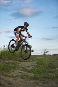 Man riding and jumping with his mountain bike outdoor