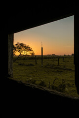 Fototapeta premium sunset on the field from a windows 