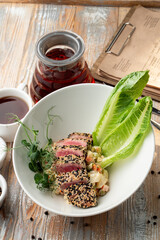 Tuna tataki with white and black sesame seeds and sprouts, fine dining dinner, top view