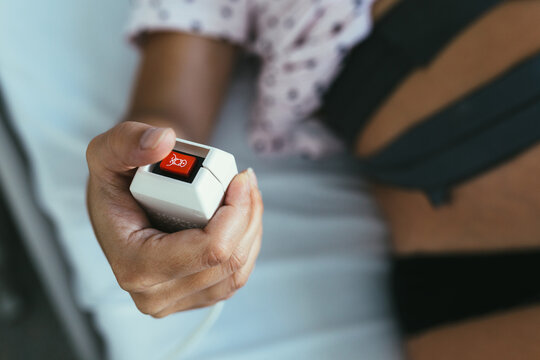 Closeup of Woman Hand Pushing the Emergency Button at the Hospit