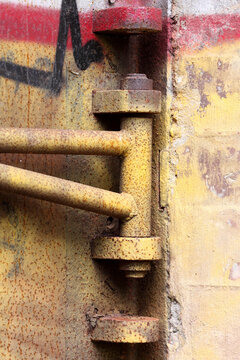 Metal hinge covered in graffiti