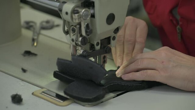 sewing together some parts of soft winter boot