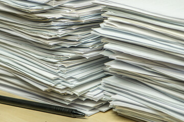 pile of paper documents and pen in the office