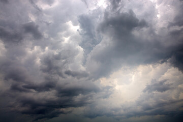 Naklejka na ściany i meble Dark ominous grey storm clouds. Dramatic sky.