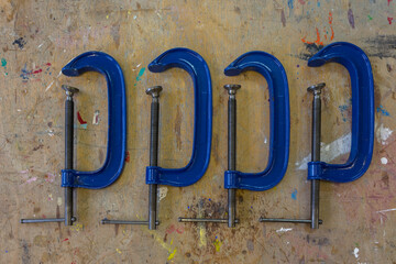 G Clamps used in a school art and design class arranged on the classroom table