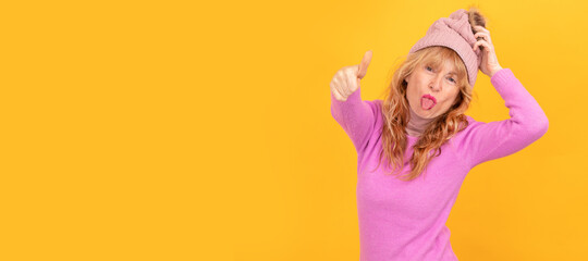 isolated rebellious senior woman sticking out her tongue