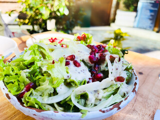  Close up healthy salad of fresh vegetables and pomegranate seeds.