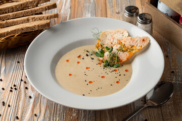 Rustic cream soup of champignons, garnished with crunchy croutons