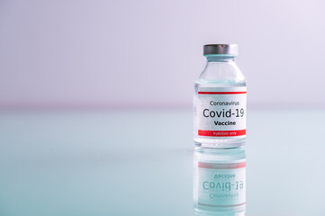 A single bottle vial of Covid-19 vaccine. Medical concept vaccination hypodermic injection...