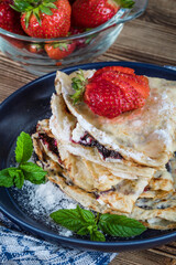 Polish pancakes with jam, cheese and strawberries.