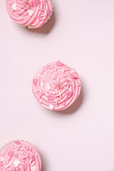 homemade vanilla cupcakes with pink buttercream frosting and heart sprinkles 