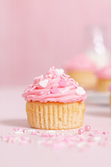 homemade vanilla cupcakes with pink buttercream frosting and heart sprinkles 