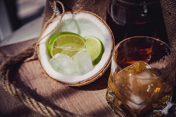 rum with ice and lime in a coconut glass