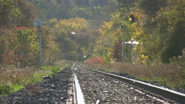 Autumn train tracks. Heat shimmer and haze on railroad tracks on a warm autumn day. Seeds blow by. Toronto, Ontario, Canada.
