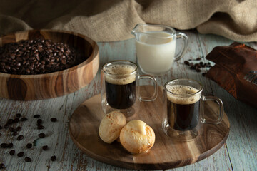 coffee with bread and cheese on the table with coffee beans