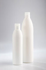 Bottle of shampoo and hair conditioner on a gray background. Detergents for hair care.