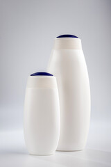 Bottle of shampoo and hair conditioner on a gray background. Detergents for hair care.