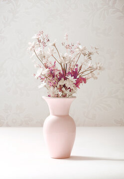 pastel pink vase with white flowers