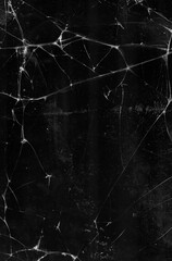 Cracked texture background. Distressed effect. Black fractured damaged tablet screen with dust...