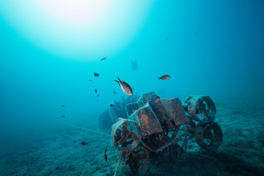 Underwater scooter sunken to make an artificial reef for fish to gather on an empty sea bed