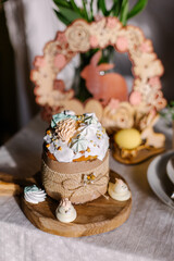 Obraz na płótnie Canvas Cute beautiful Easter cake on a decorated table. Religious traditional Christian food. Orthodox Easter kulich with glaze and meringue. Still life. Delicious homemade russian pastries. Dessert sweet