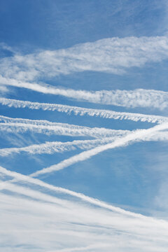 Airplane vapor trails in blue sky