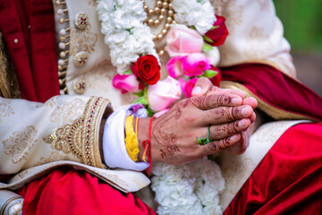 Fototapeta na wymiar Indian Hindu couple's hands close up, wedding ceremony, religious items and rituals, pooja