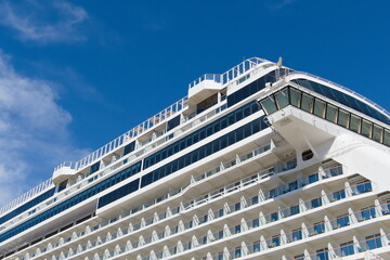 Isolated corner of a cruise viewed form the dock, displaying the bridge, and rooms and th etop deck